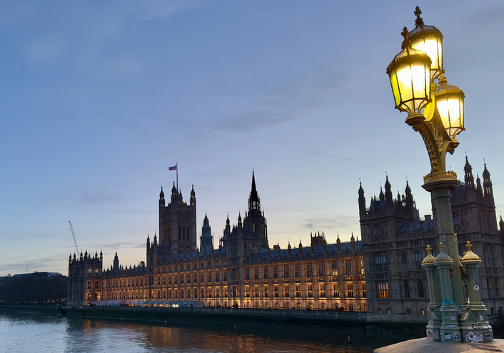 The Houses of Parliament in Westminster, London at dusk with an historic lamp on Westminster Bridge in the foreground. Autumn Budget 2025: Predictions